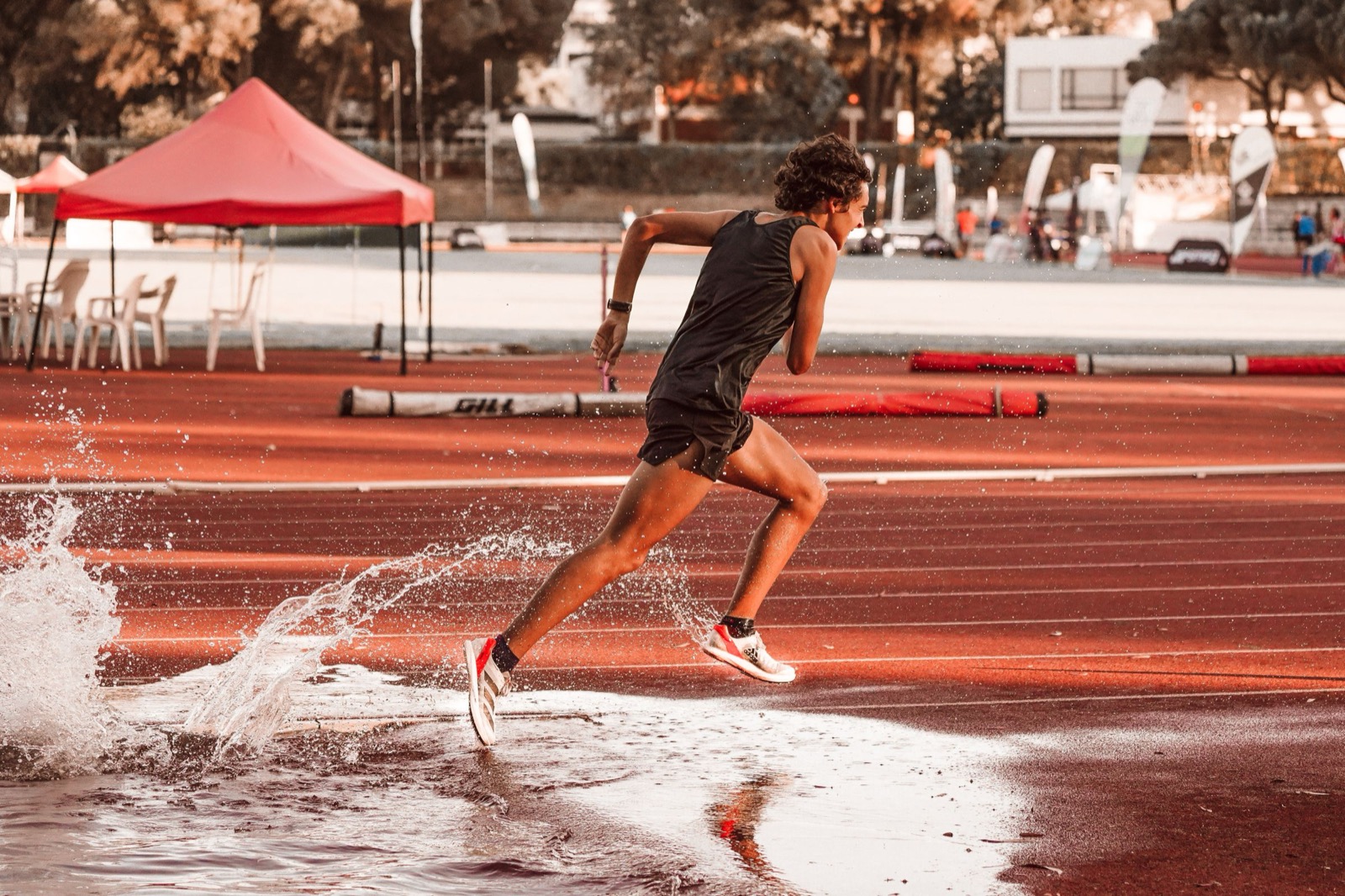 Sprinter in volle vaart op een atletiekbaan, symbool voor de kracht van de D-stijl die kan doorschieten